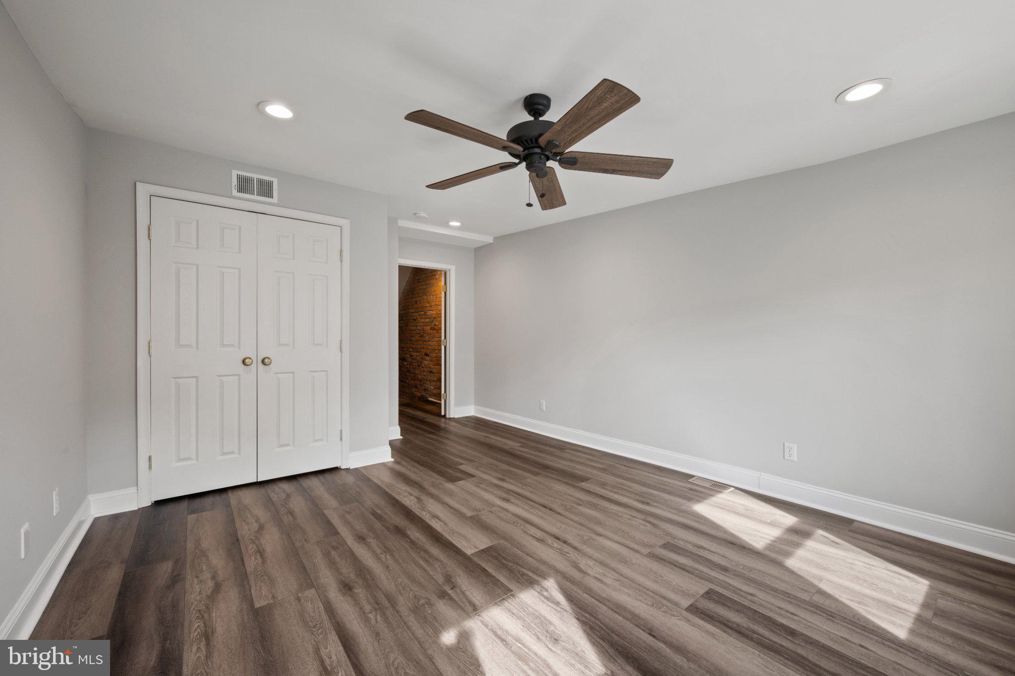 615 South Clinton Street Baltimore, MD 21224 - Photo 22 of 39 a view of empty room with wooden floor