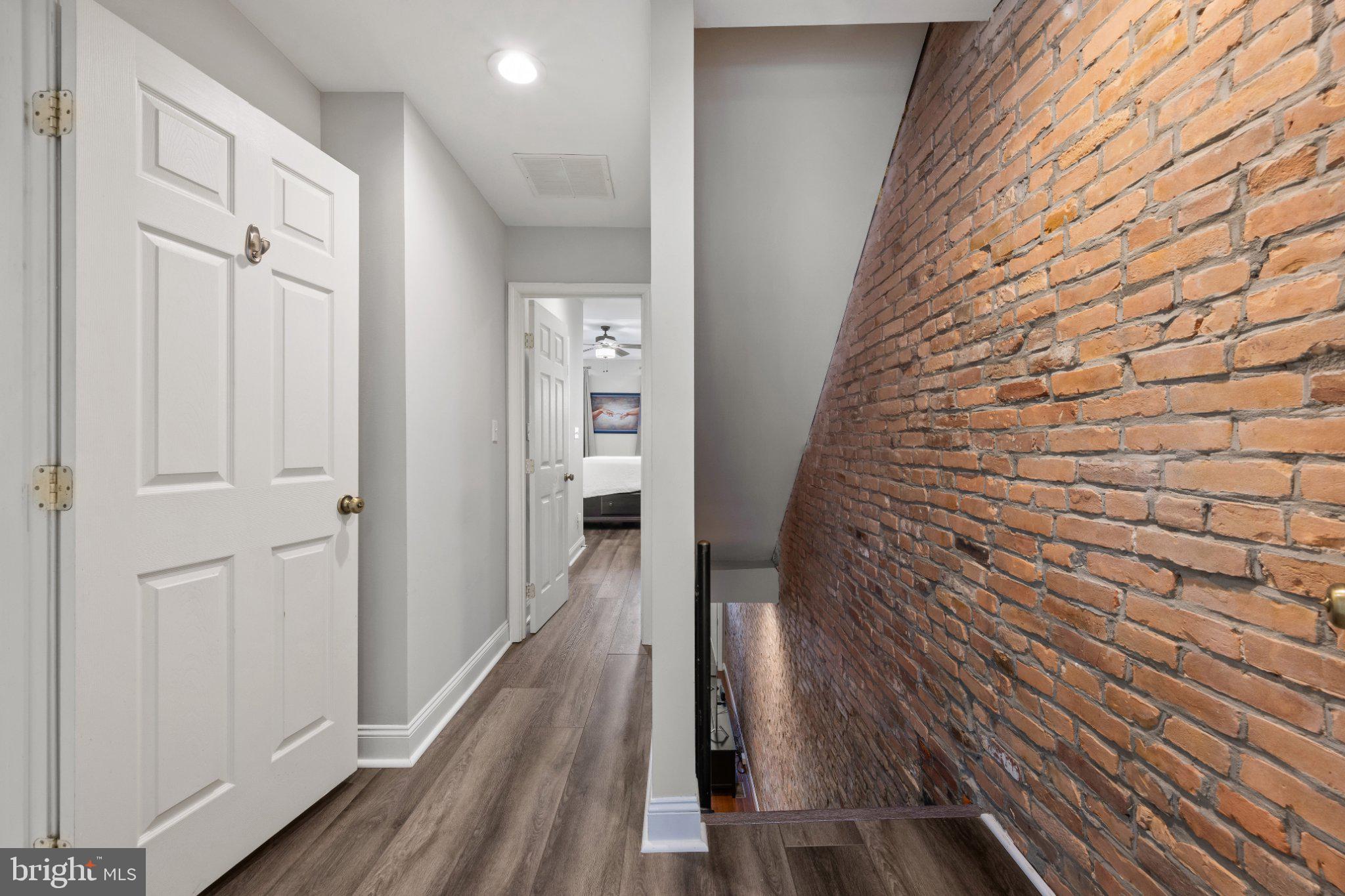 615 South Clinton Street Baltimore, MD 21224 - Photo 23 of 39 a view of a hallway with wooden floor and staircase