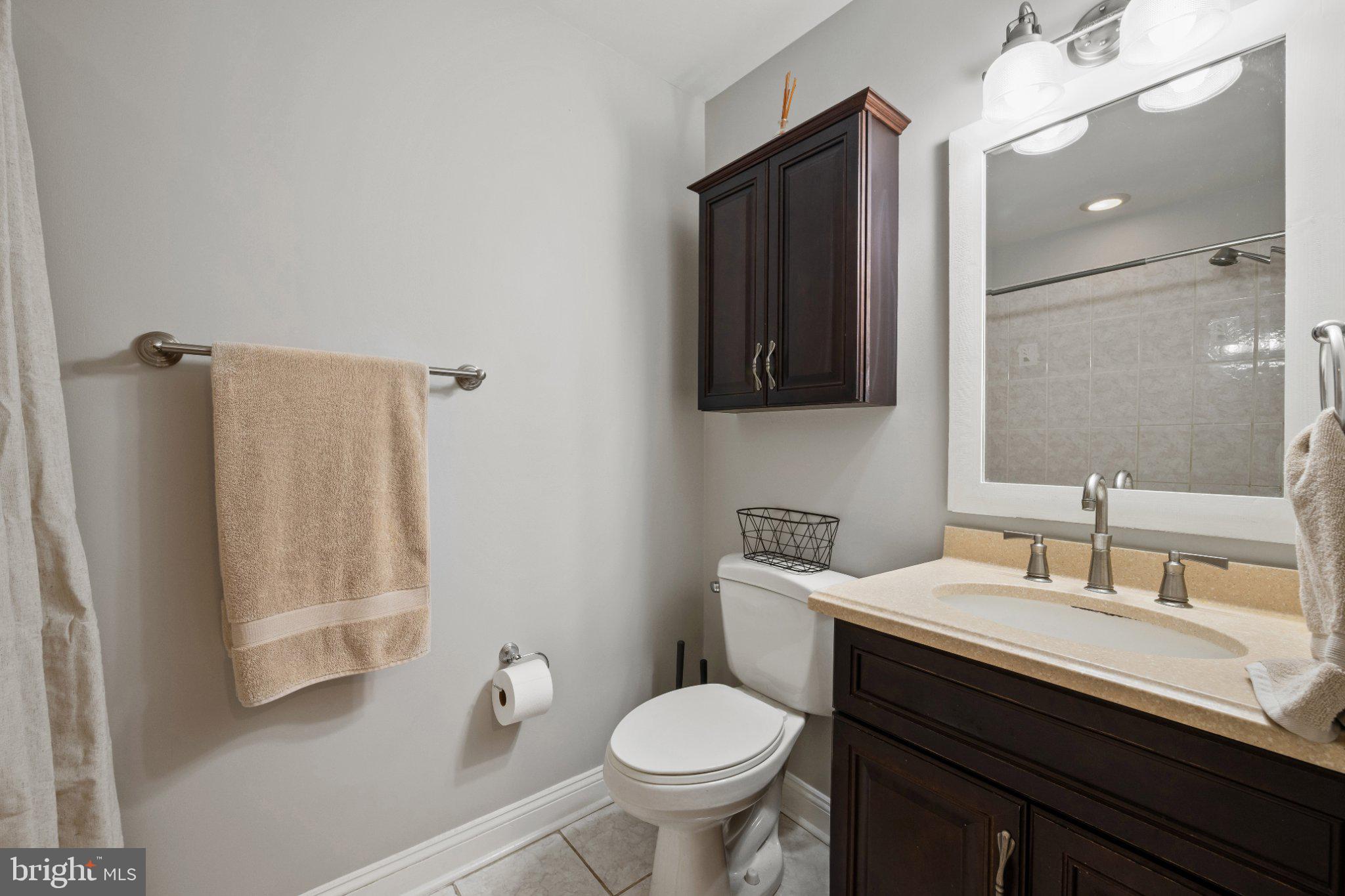 615 South Clinton Street Baltimore, MD 21224 - Photo 24 of 39 a bathroom with a toilet sink and mirror