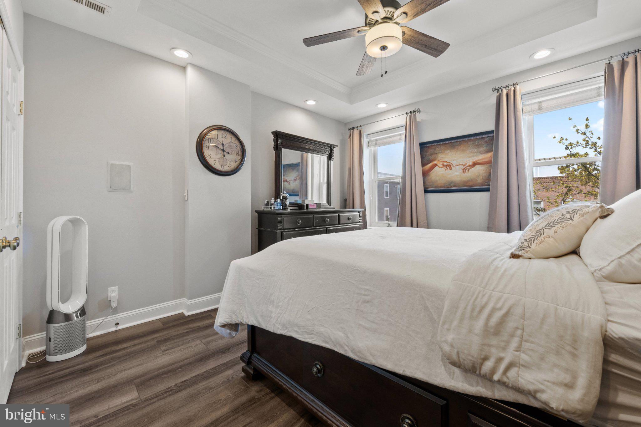 615 South Clinton Street Baltimore, MD 21224 - Photo 27 of 39 a bedroom with a bed and a chandelier