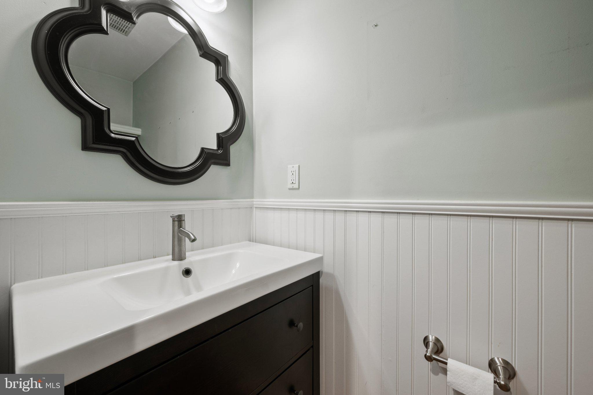 615 South Clinton Street Baltimore, MD 21224 - Photo 10 of 39 a bathroom with a sink and a mirror