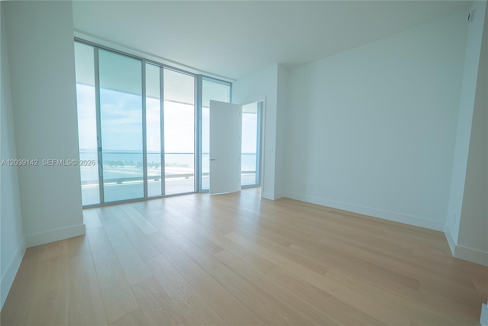 175 Southeast 25th Road, Unit 702 Miami, FL 33129 - Photo 10 of 30 an empty room with wooden floor and windows
