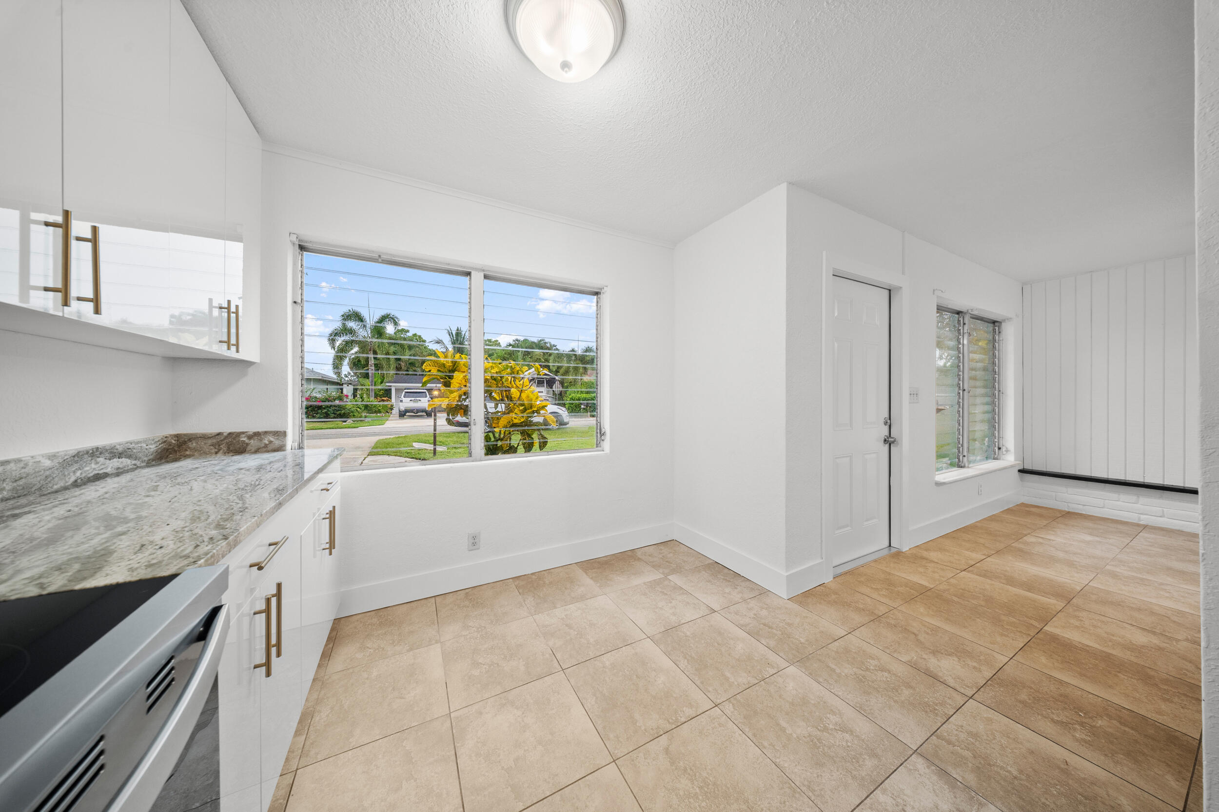 2904 Southeast Bamboo Street Stuart, FL 34997 - Photo 12 of 51 a view of kitchen with granite countertop cabinets and window