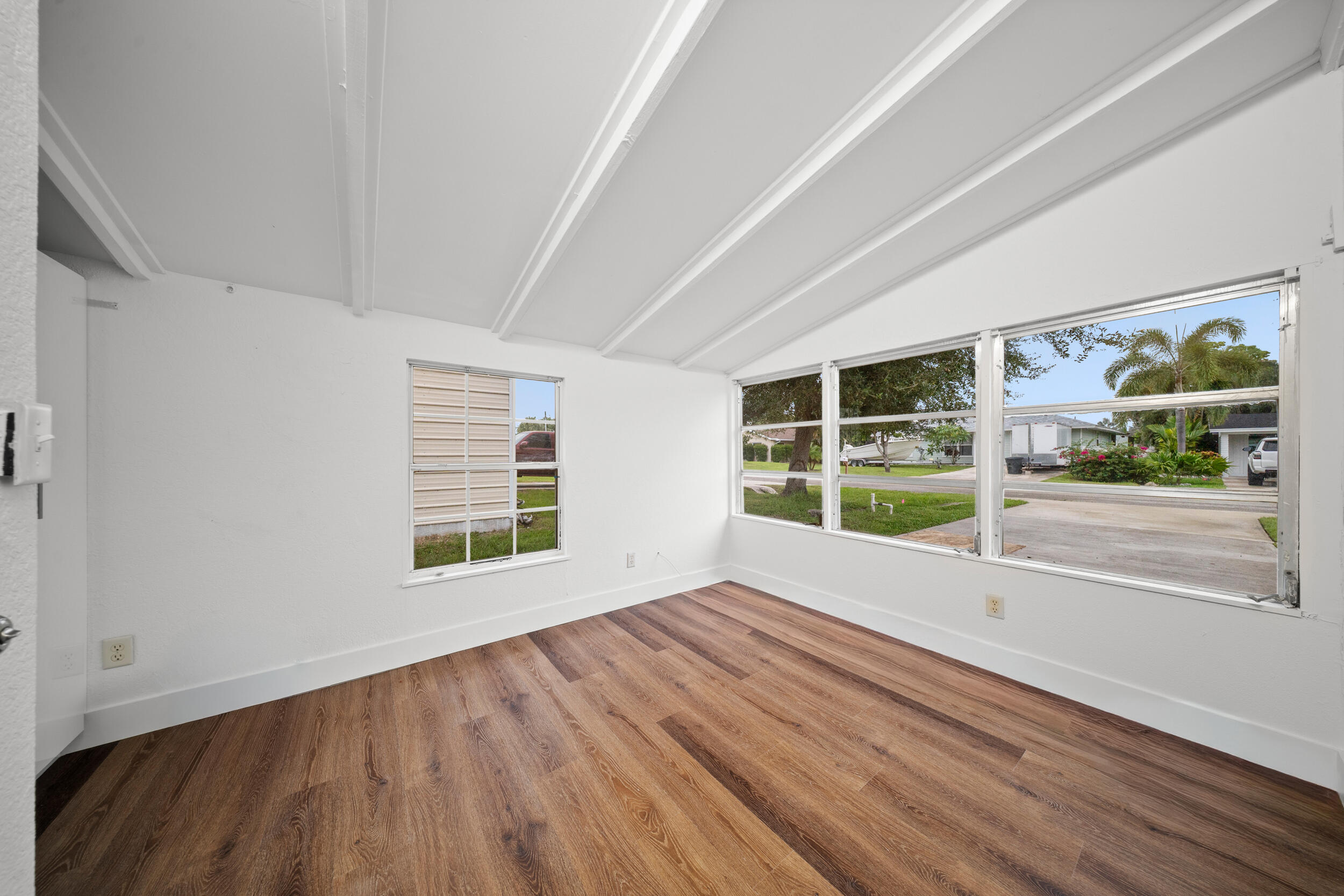 2904 Southeast Bamboo Street Stuart, FL 34997 - Photo 24 of 51 a view of an empty room with a window and wooden floor