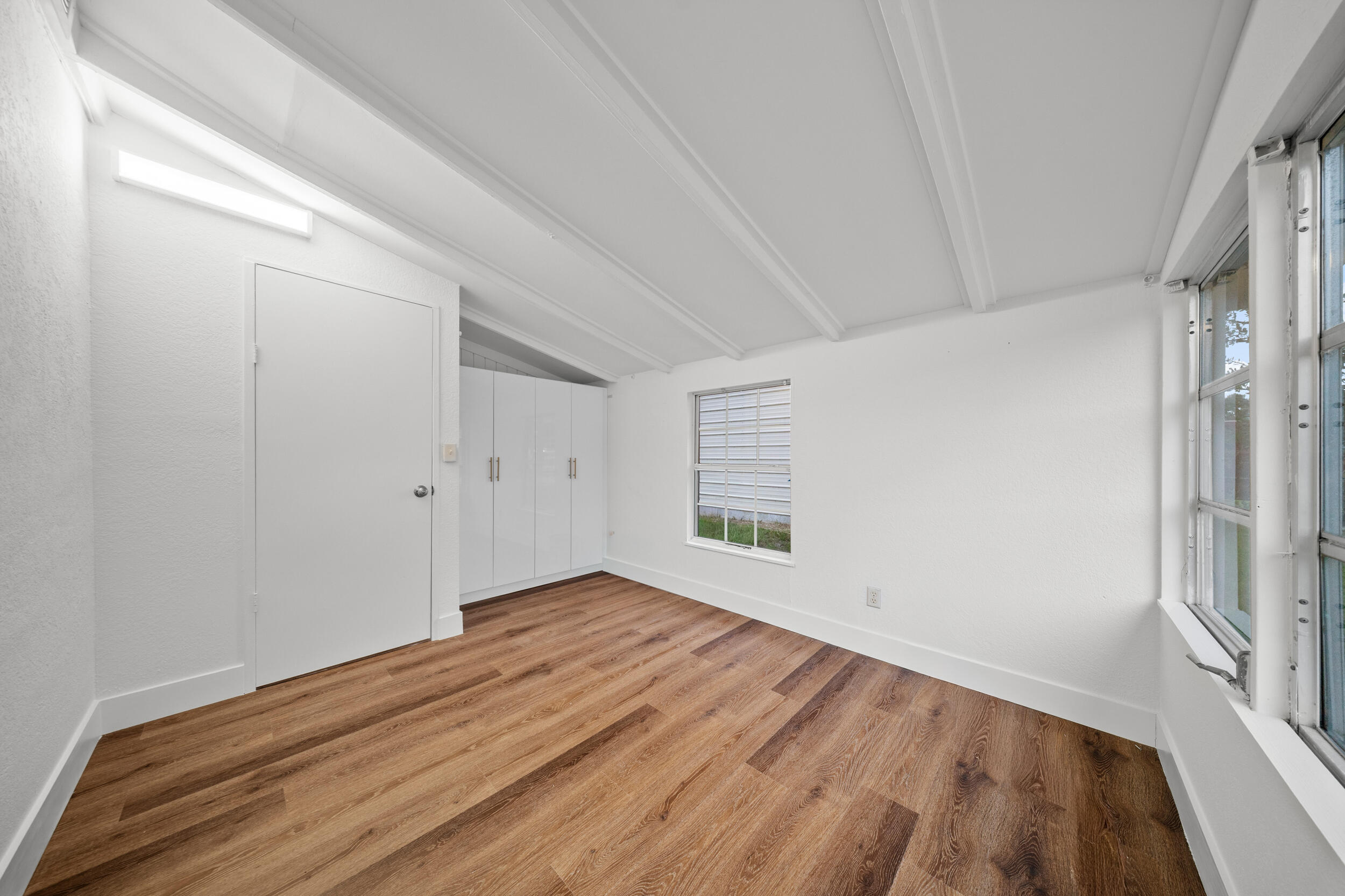 2904 Southeast Bamboo Street Stuart, FL 34997 - Photo 25 of 51 wooden floor in an empty room with a window