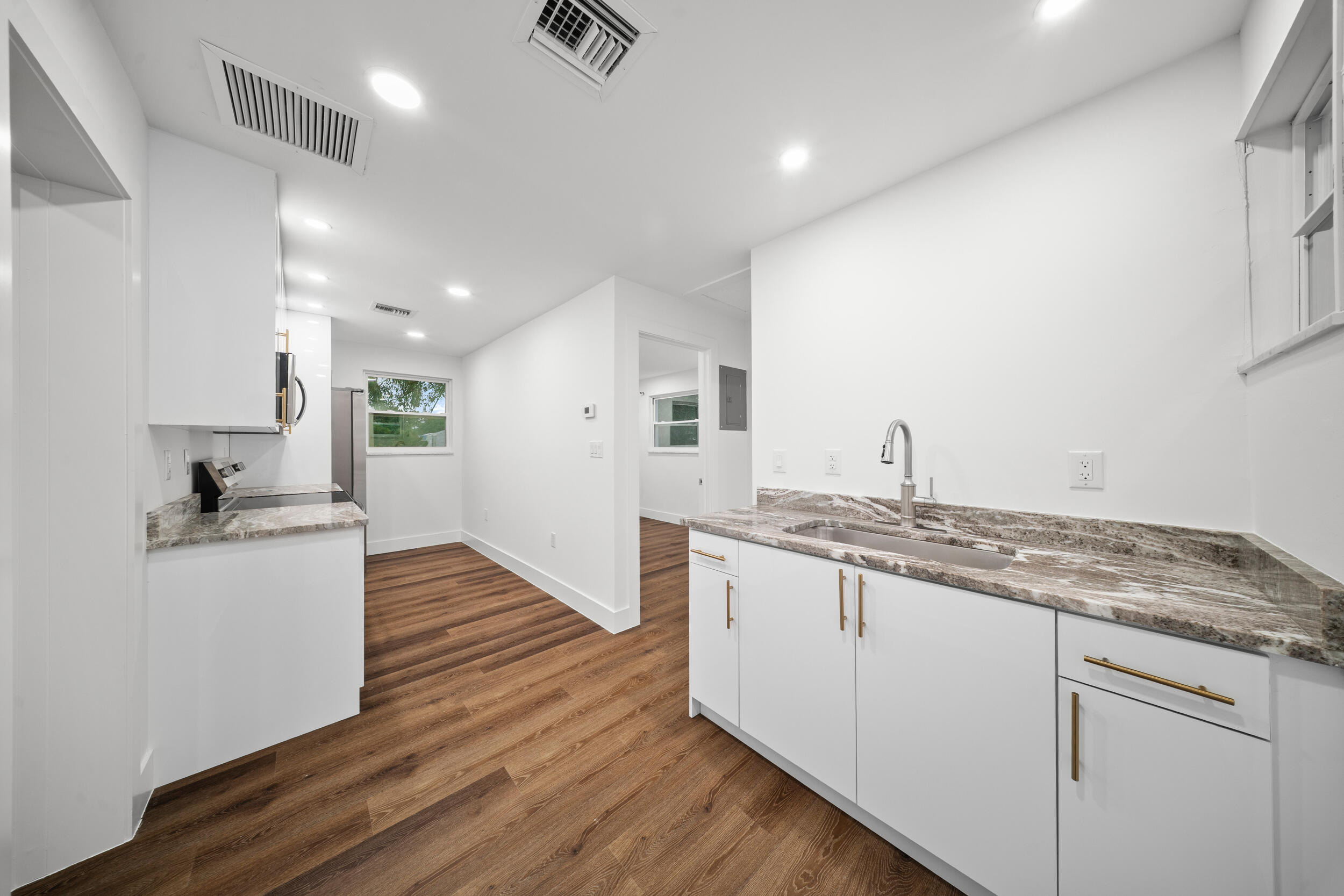 2904 Southeast Bamboo Street Stuart, FL 34997 - Photo 37 of 51 a kitchen with granite countertop a sink and a stove top oven