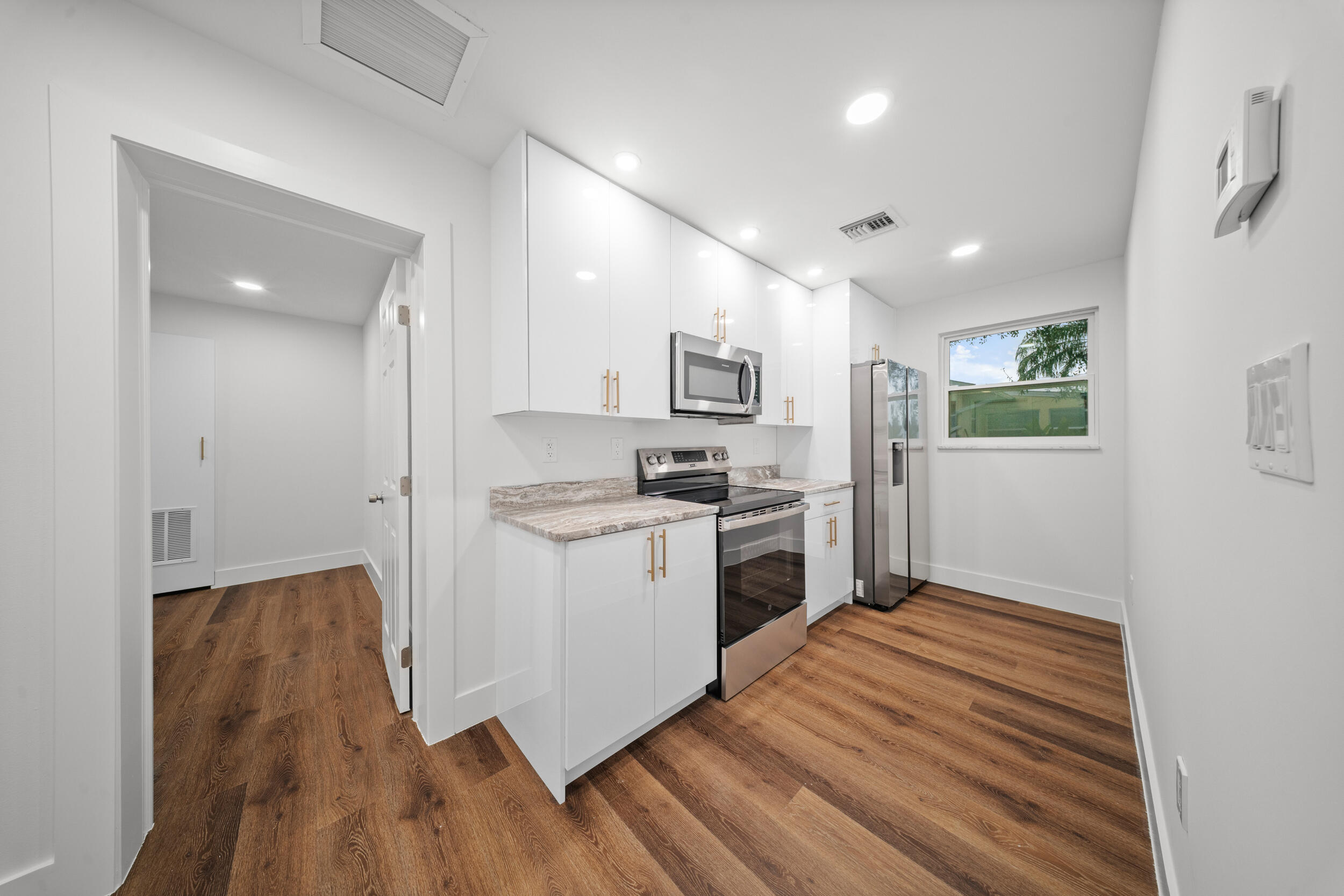 2904 Southeast Bamboo Street Stuart, FL 34997 - Photo 38 of 51 a kitchen with a refrigerator and a stove top oven