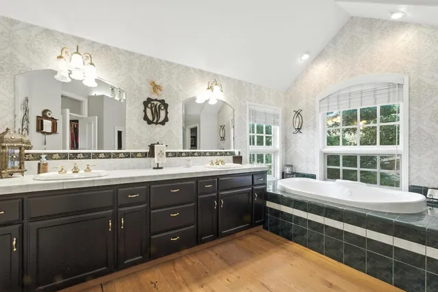 a bathroom with a double vanity sink mirror and