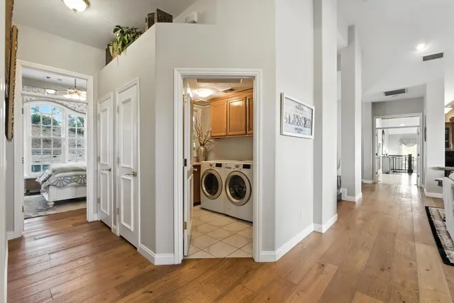 a view of a hallway with wooden floor and a bedroom