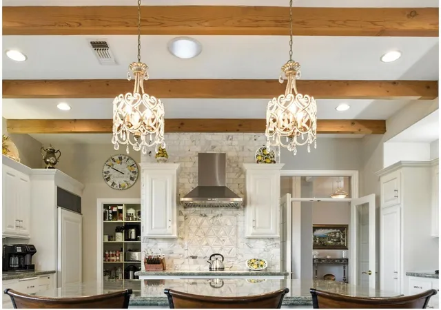 a kitchen with granite countertop white cabinets and a sink