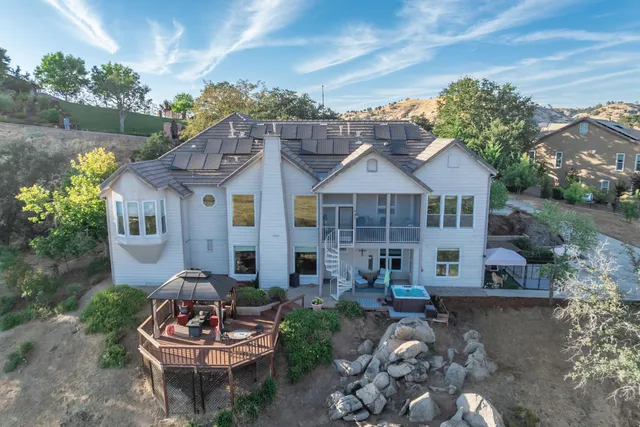 a view of a backyard with a garden and trees