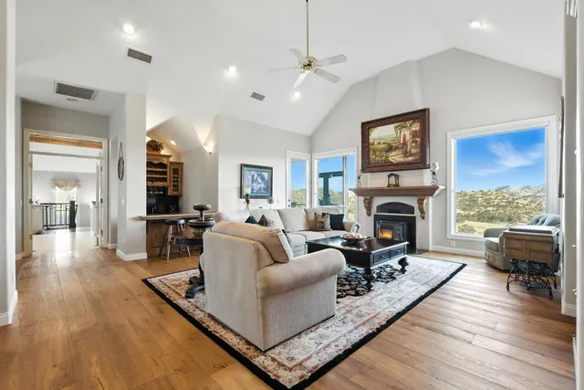 a living room with furniture a fireplace and a flat screen tv