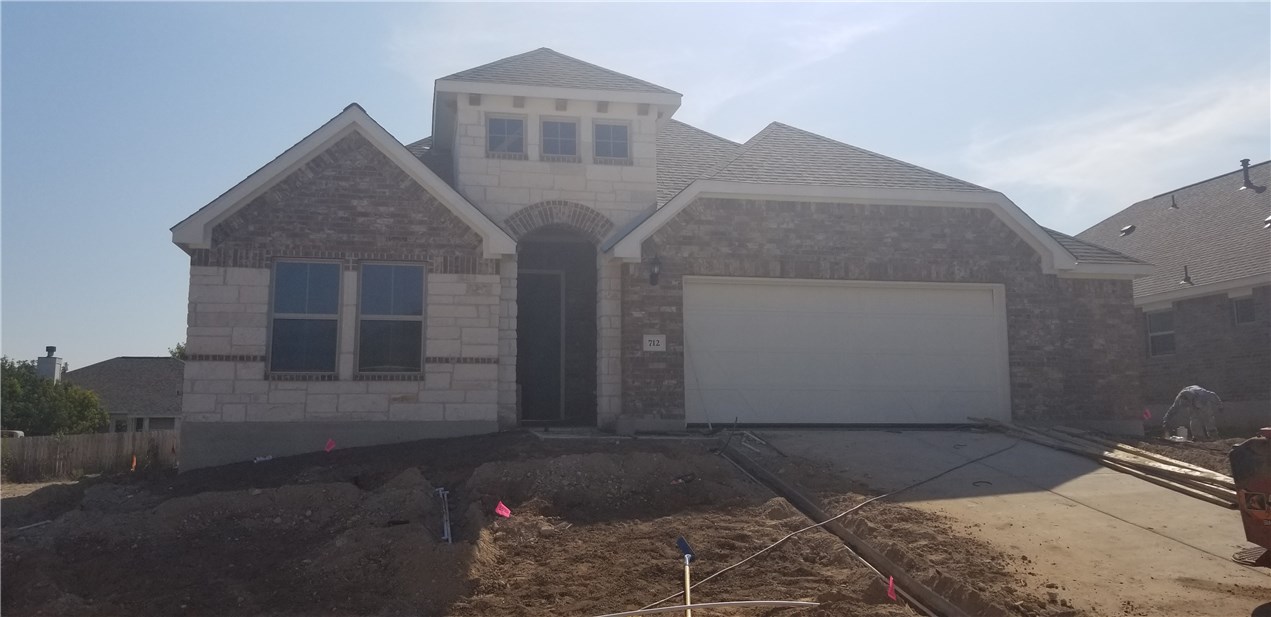 a front view of a house with parking space