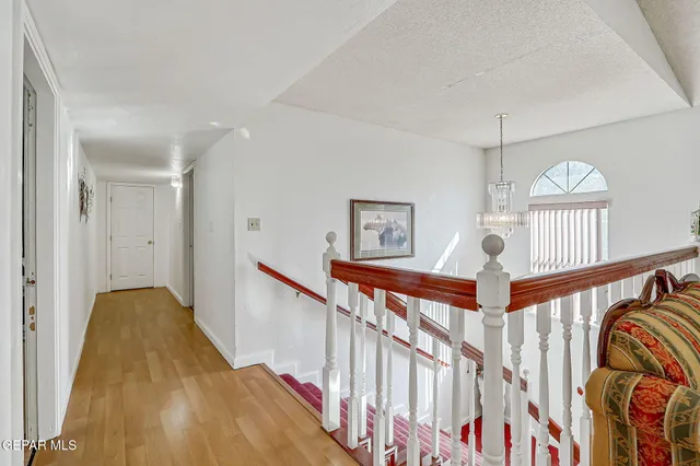 a living room with lots of furniture and a chandelier