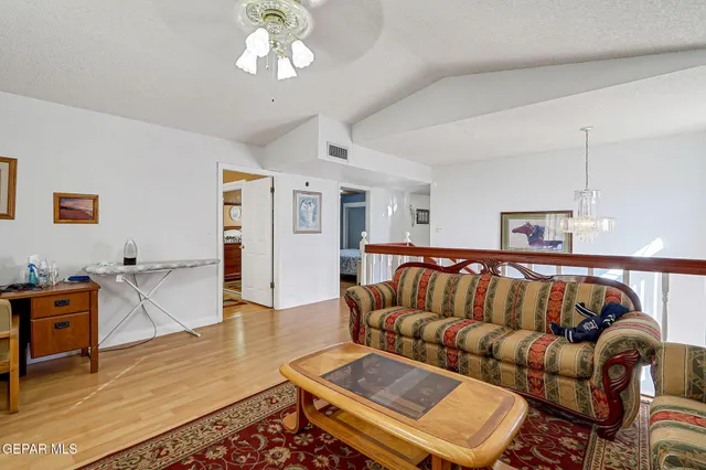 a bedroom with a bed and a flat tv screen on dresser