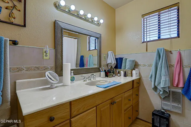 a bedroom with a bed and a mirror on dresser