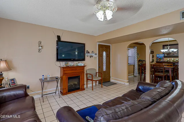a living room with fireplace furniture and a flat screen tv