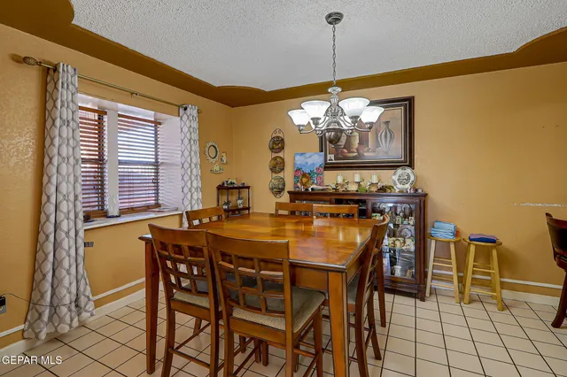 a view of a dining room with furniture and chandelier