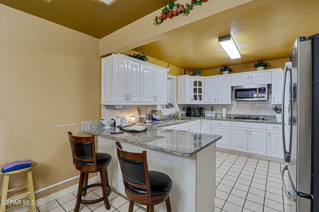 a kitchen with stainless steel appliances granite countertop a sink and cabinets