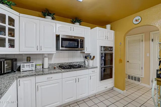 a kitchen with a sink a stove and refrigerator