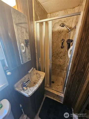 a bathroom with a sink toilet and shower