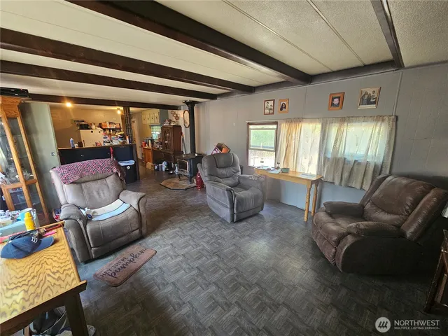 a living room with furniture and a floor to ceiling window