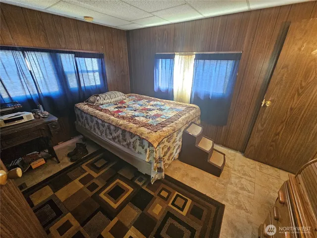 a bedroom with a bed and a mirror