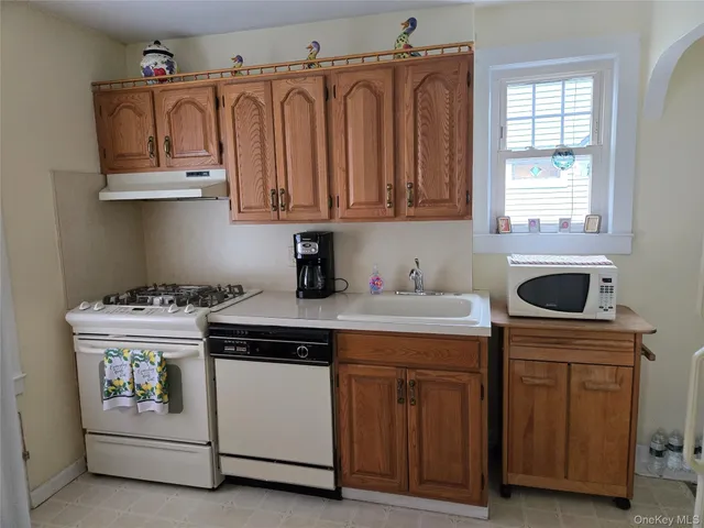 a kitchen with stainless steel appliances granite countertop a stove and a microwave