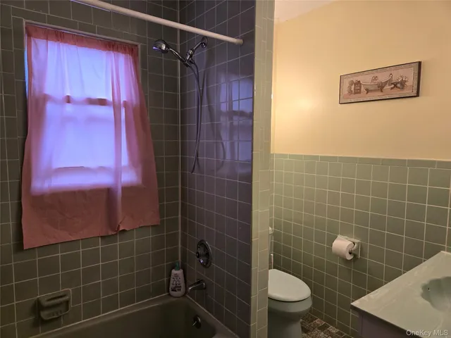 a bathroom with a toilet and shower