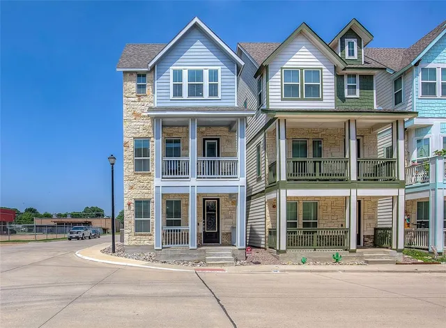 a front view of a residential apartment building with a yard