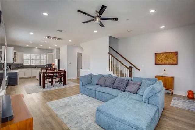 a living room with furniture and kitchen view