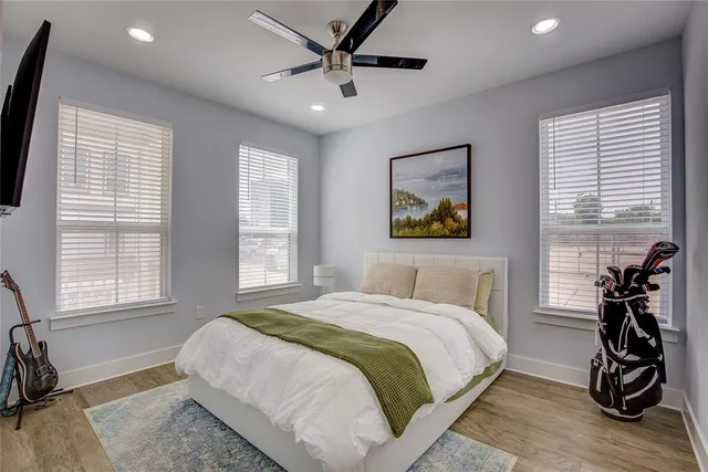 a bedroom with a bed and a wooden floor