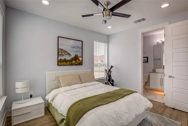 a bedroom with a bed and a painting on the wall