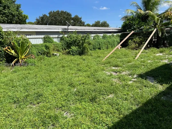 a view of a backyard with plants and a lake view