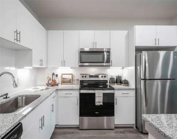 a kitchen with a sink white stove and refrigerator