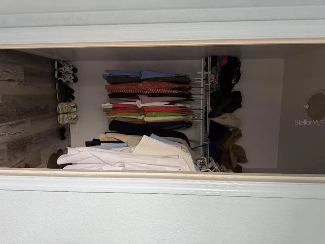 a bedroom with a bed and cabinet