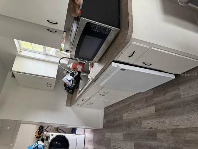 a room with a bed and a dresser