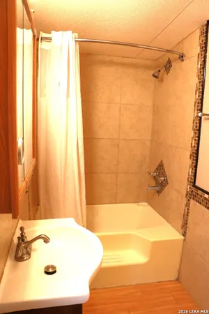 a bathroom with a bathtub and a shower