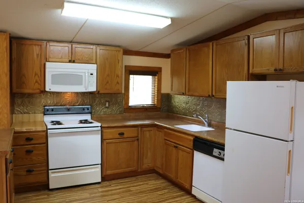 a kitchen with a refrigerator sink and cabinets