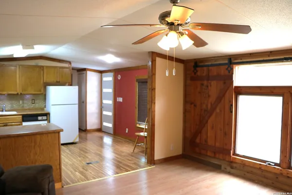 a view of a kitchen with a sink and a refrigerator