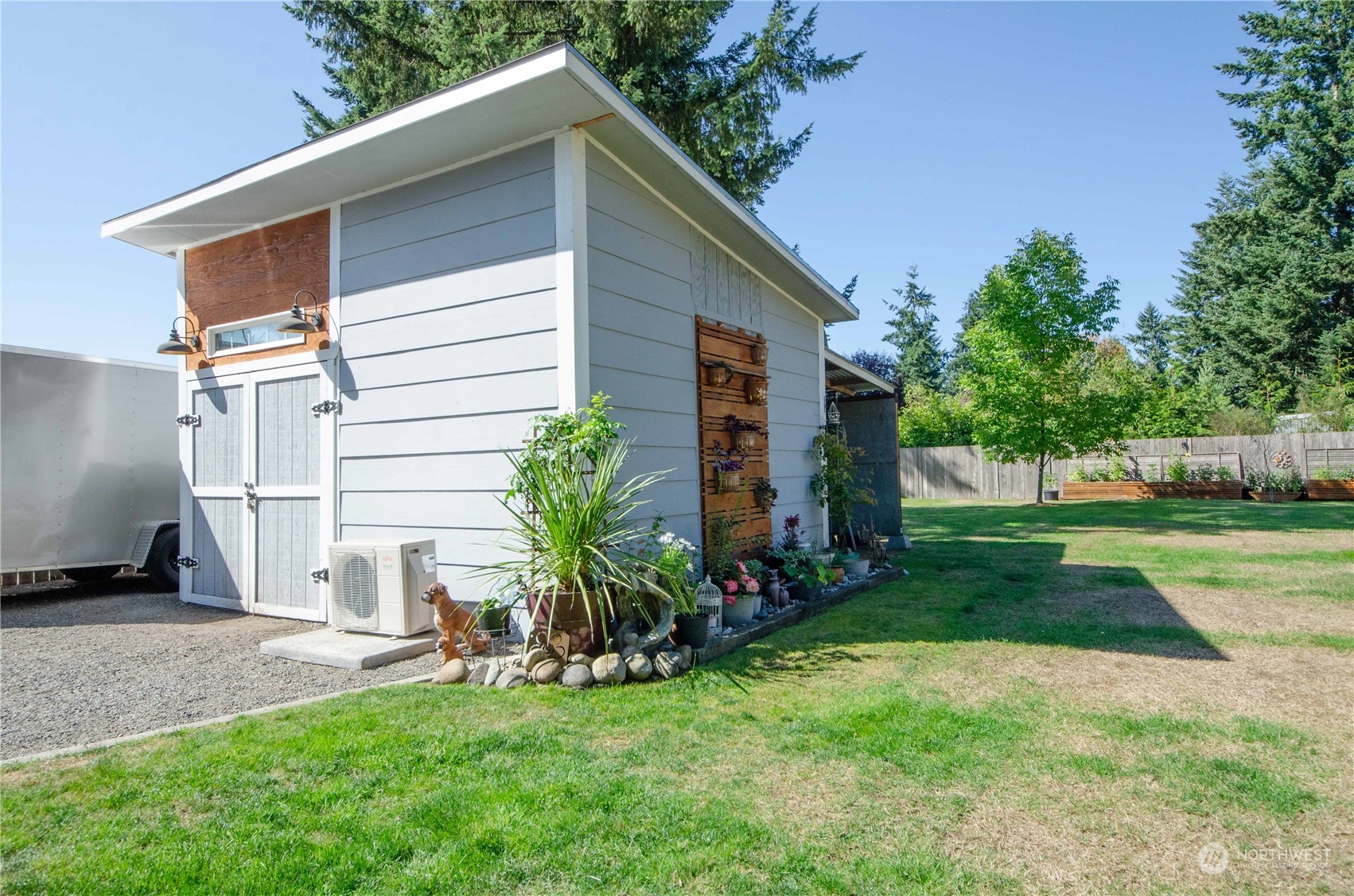 18425 Apricot Street Southwest Rochester, WA 98579 - Photo 20 of 39 a backyard of a house with plants and large tree