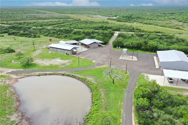 an aerial view of a house with a yard lake view and mountain view