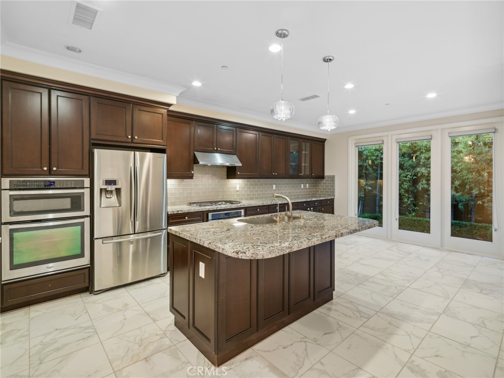 58 Lupari Irvine, CA 92618 - Photo 3 of 60 a kitchen with stainless steel appliances granite countertop a refrigerator and a sink