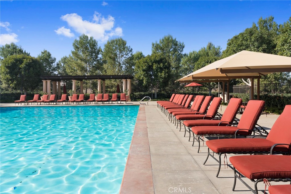 58 Lupari Irvine, CA 92618 - Photo 37 of 60 a view of swimming pool with lawn chairs under an umbrella
