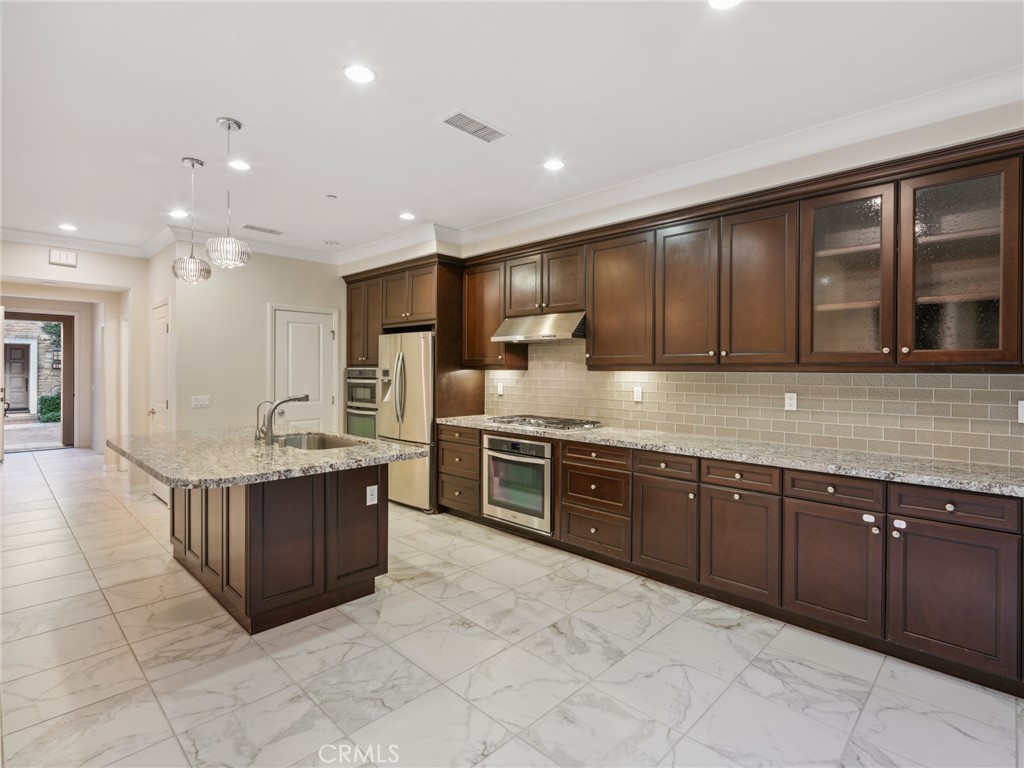 58 Lupari Irvine, CA 92618 - Photo 5 of 60 a large kitchen with stainless steel appliances lots of counter top space
