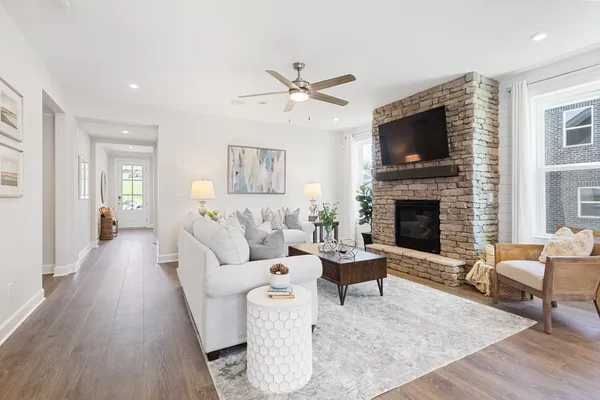 a living room with furniture a flat screen tv and a fireplace