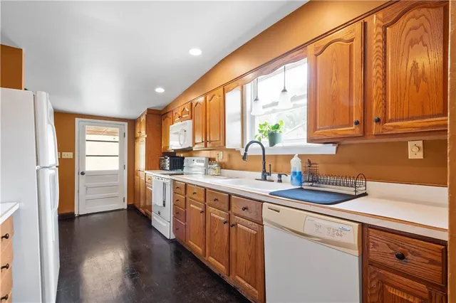a kitchen with a sink a counter top space and stainless steel appliances