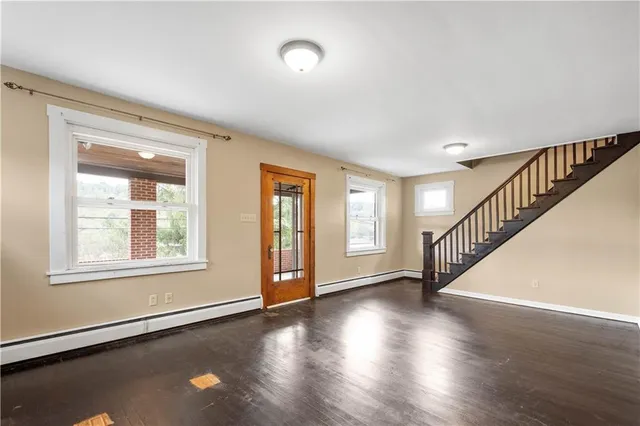 a view of an entryway with wooden floor and windows
