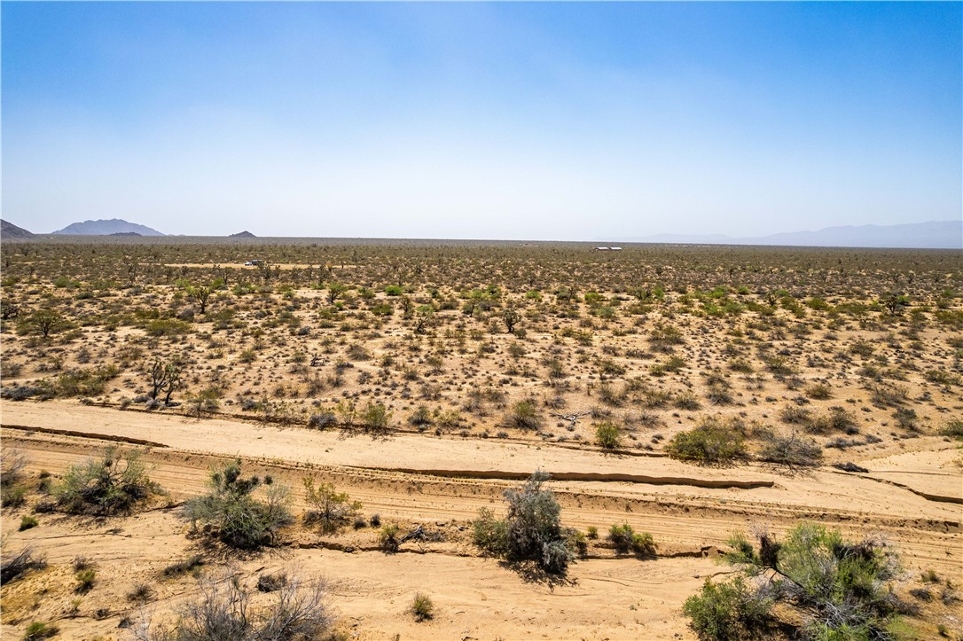 0 East Arroyo Road Yucca, AZ 86438 - Photo 19 of 25 Expansive desert landscape featuring natural vegetation and distant mountains under a clear sky