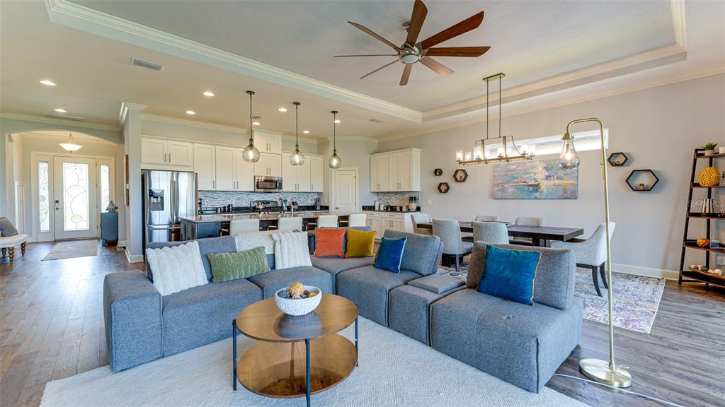 4511 Terrazza Court Lakewood Ranch, FL 34211 - Photo 5 of 65 a living room with lots of furniture kitchen view and a chandelier